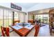 Sunroom features a dining set and offers a view into the living room at 237 Southampton Ln # 275, Venice, FL 34293