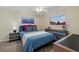 Cozy bedroom with dresser and blue bedding at 255 The Esplanade N # 202, Venice, FL 34285
