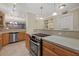 Modern kitchen with stainless steel appliances and light wood cabinets at 255 The Esplanade N # 202, Venice, FL 34285