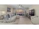 Bright living room with ocean view, featuring comfortable seating and tile floors at 255 The Esplanade N # 202, Venice, FL 34285