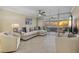 Living room with stunning sunset view and comfortable seating at 255 The Esplanade N # 202, Venice, FL 34285