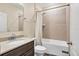 Well-lit bathroom with a granite vanity and a tiled shower-over-tub at 2737 Cottage Ln, North Port, FL 34286
