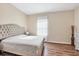 Well-lit bedroom with a large bed and wood floors at 2737 Cottage Ln, North Port, FL 34286