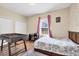 Cozy bedroom with hardwood floors and a sunny window overlooking the backyard at 2737 Cottage Ln, North Port, FL 34286