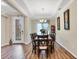 Bright dining area features modern chandelier, neutral colors, and hardwood floors at 2737 Cottage Ln, North Port, FL 34286