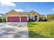 Charming one-story home with a two-car garage, landscaped yard, and inviting front entrance at 2737 Cottage Ln, North Port, FL 34286