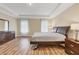 Spacious main bedroom featuring tray ceilings and wood floors at 2737 Cottage Ln, North Port, FL 34286