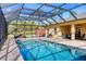 Gorgeous screened-in pool with a relaxing hot tub and a shed in the backyard at 2737 Cottage Ln, North Port, FL 34286