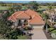 House with tile roof, 2-car garage, and lush landscaping at 298 Montelluna Dr, North Venice, FL 34275