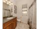 Clean bathroom with shower/tub combo, single vanity, and window at 298 Montelluna Dr, North Venice, FL 34275
