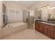 Bathroom features a soaking tub, walk-in shower, and double vanity at 298 Montelluna Dr, North Venice, FL 34275