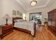 Comfortable bedroom with wood furniture, large window, and access to the pool at 298 Montelluna Dr, North Venice, FL 34275