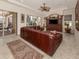 Gathering room with a large sectional sofa, TV, and access to patio at 298 Montelluna Dr, North Venice, FL 34275