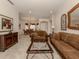 Open living and dining area with tile floors and rich brown furniture at 298 Montelluna Dr, North Venice, FL 34275