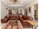Bright living room featuring a large leather sectional and access to backyard at 298 Montelluna Dr, North Venice, FL 34275