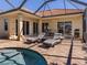 Spacious pool area with lounge chairs and access to the house at 298 Montelluna Dr, North Venice, FL 34275