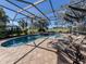 Relaxing pool and spa area with patio furniture under a screened enclosure at 298 Montelluna Dr, North Venice, FL 34275