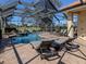 Enclosed pool and spa with lounge chairs and golf course view at 298 Montelluna Dr, North Venice, FL 34275