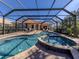 Stunning pool and spa with screened enclosure and view of the home at 298 Montelluna Dr, North Venice, FL 34275