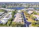 Community aerial view overlooking lakeside property, mature trees, and well-maintained landscaping at 301 Pinebrook Club Dr # 1, Venice, FL 34285
