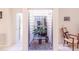 Bright atrium with natural light, a decorative plant, and access to other rooms at 301 Pinebrook Club Dr # 1, Venice, FL 34285