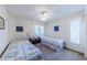 Bright bedroom with two beds, ceiling fan, and lots of natural light at 301 Pinebrook Club Dr # 1, Venice, FL 34285