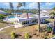 A clubhouse with a view of the pool and lake stands as a central gathering spot in a community at 301 Pinebrook Club Dr # 1, Venice, FL 34285