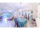 Bright dining room with tiled floor, chandelier, and sliding glass doors to the outdoor patio at 301 Pinebrook Club Dr # 1, Venice, FL 34285