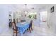 Dining area featuring tile floors, mirrored walls, and a pass-through to the kitchen at 301 Pinebrook Club Dr # 1, Venice, FL 34285