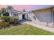 Charming front entrance with well maintained yard, stone landscaping, and a smooth walkway at 301 Pinebrook Club Dr # 1, Venice, FL 34285