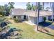 Charming one-story home featuring an attached garage and a well-maintained lawn and mature landscaping at 301 Pinebrook Club Dr # 1, Venice, FL 34285