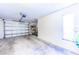 Spacious garage with an open garage door, providing ample storage space at 301 Pinebrook Club Dr # 1, Venice, FL 34285