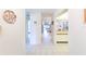 Bright hallway showcasing neutral paint, tile flooring, and views to kitchen and living area at 301 Pinebrook Club Dr # 1, Venice, FL 34285