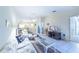 Bright living area with tile flooring, ceiling fan, and open access to the dining area at 301 Pinebrook Club Dr # 1, Venice, FL 34285