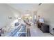 Spacious living area featuring tile floors, ceiling fan, and an open layout at 301 Pinebrook Club Dr # 1, Venice, FL 34285
