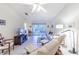 Bright, open living room with tile flooring, ceiling fan, and sliding glass doors at 301 Pinebrook Club Dr # 1, Venice, FL 34285