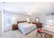 Bright primary bedroom featuring neutral walls, white carpet, fan, and furnishings at 301 Pinebrook Club Dr # 1, Venice, FL 34285