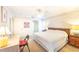 Bright primary bedroom featuring neutral walls, white carpet, fan, and furnishings at 301 Pinebrook Club Dr # 1, Venice, FL 34285