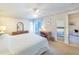 Bright primary bedroom featuring neutral walls, white carpet, fan, and furnishings at 301 Pinebrook Club Dr # 1, Venice, FL 34285