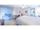 Bright primary bedroom featuring neutral walls, white carpet, fan, and furnishings at 301 Pinebrook Club Dr # 1, Venice, FL 34285