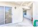 Cozy covered patio with sliding glass doors and a well-maintained concrete flooring at 301 Pinebrook Club Dr # 1, Venice, FL 34285