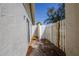 Enclosed patio with concrete slab and white stucco wall with a white wooden fence at 301 Pinebrook Club Dr # 1, Venice, FL 34285