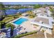 Aerial view of a community pool and lake offering a relaxing and scenic recreational space at 301 Pinebrook Club Dr # 1, Venice, FL 34285