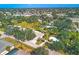 An aerial view of a charming property nestled among lush trees and a quiet neighborhood at 3151 Datura Rd, Venice, FL 34293