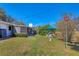 A beautiful backyard featuring a lush green lawn, shaded patio, and outdoor seating area, perfect for relaxation and entertainment at 3151 Datura Rd, Venice, FL 34293