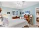 Bright bedroom with light blue walls, wooden furniture, and large windows with shutters at 3151 Datura Rd, Venice, FL 34293