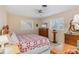 Cozy bedroom featuring a bed, wooden dresser, and bright natural light at 3151 Datura Rd, Venice, FL 34293