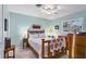 Comfortable bedroom with a wooden bed frame, vintage furniture, and window with shutters at 3151 Datura Rd, Venice, FL 34293