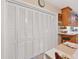Bright dining area with white bi-fold doors and tile flooring, adjacent to the kitchen at 3151 Datura Rd, Venice, FL 34293