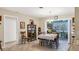 Traditional dining room with tile floors, wooden furnishings, and natural light from sliding doors at 3151 Datura Rd, Venice, FL 34293